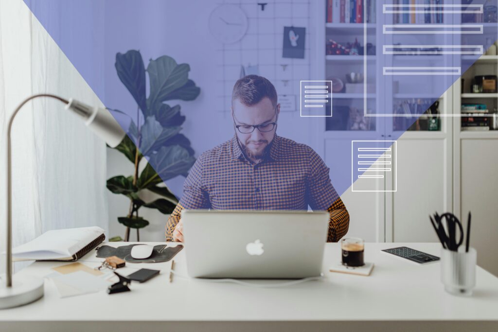 Man working from home on a laptop with digital overlays in a modern office setting.